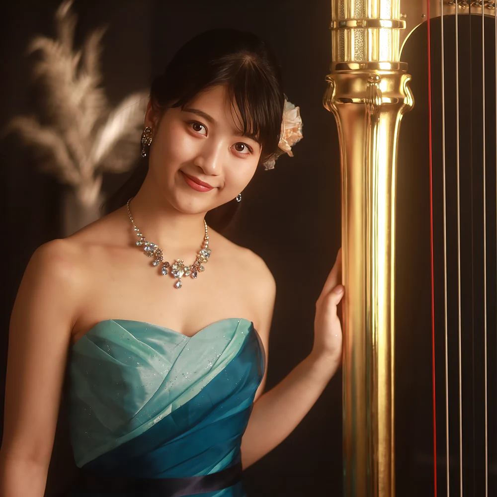 Award-winning classical harpist Nagisa Tanaka posing with her Lyon and Healy Style 11 harp.